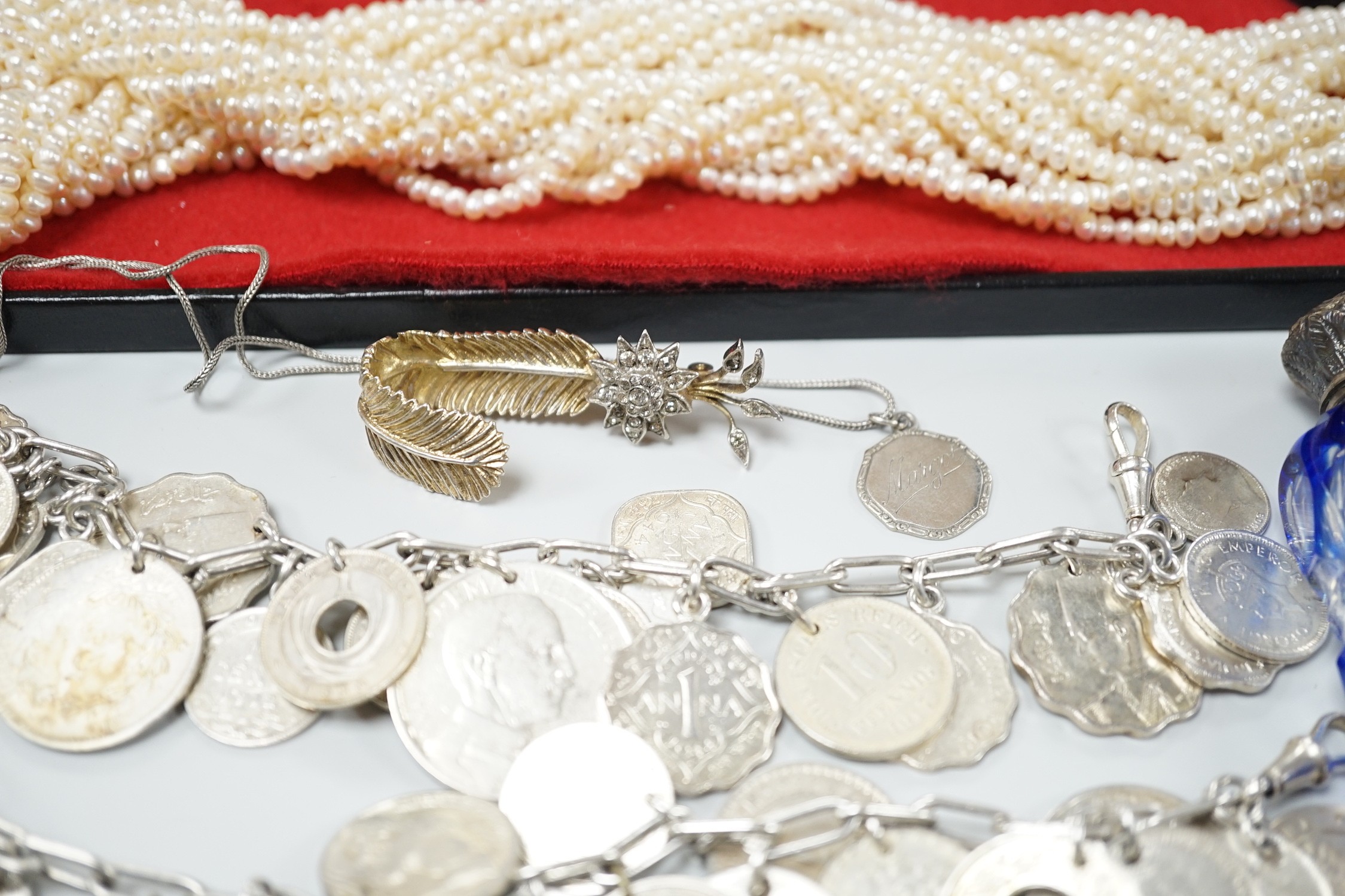 Mixed jewellery including a modern freshwater? pearl torsade necklace, 52cm, a Christian Dior 58 paste set brooch, two coin bracelets, a single strand cultured pearl necklace, mounted glass scent bottle, etc.